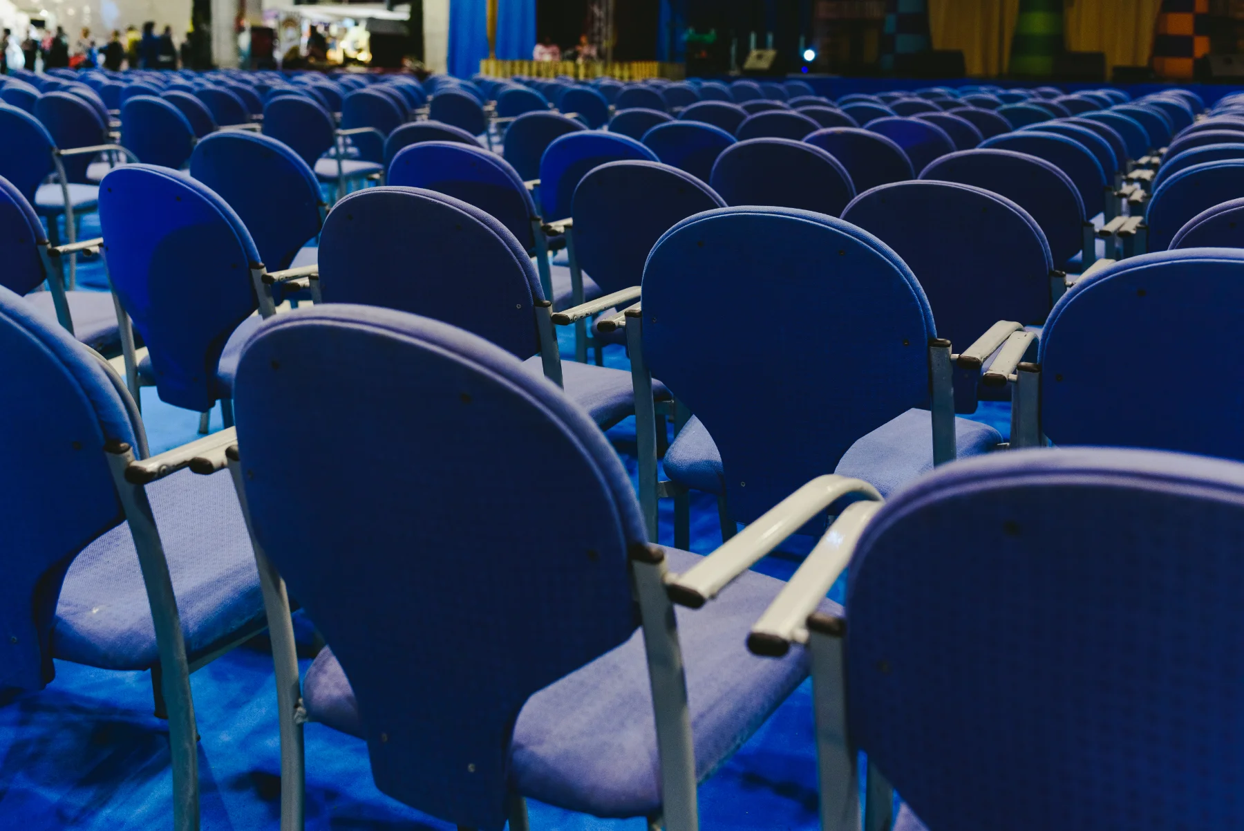 Many empty blue row chairs in a theater Many empty blue row chairs in a theater