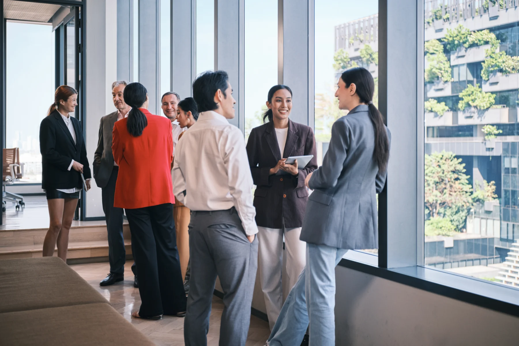 Multiracial business people talking together with cheerfulness in seminar hall.